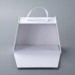 Trapezoidal book-style rigid box with straps