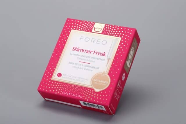 This is a custom-designed box with a vibrant red and pink color scheme, embellished with gold dot accents. It is specifically crafted to hold caffeine-infused eye masks from the Foreo Shimmer Freak Advanced Collection.