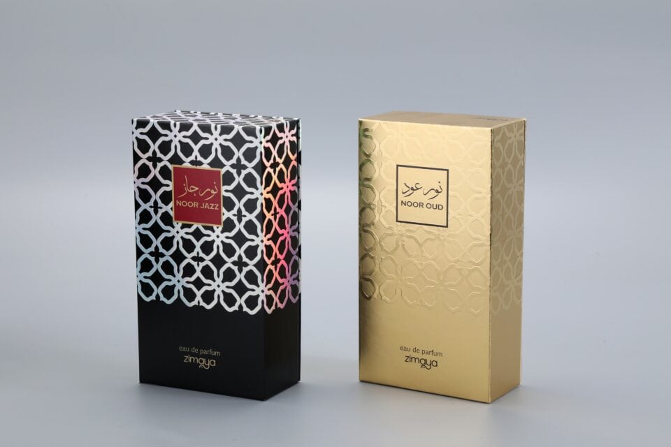 As a manufacturer of custom box packaging, this image showcases two examples of our work. On the left, there is a sophisticated black box featuring a vibrant, eye-catching pattern. On the right, you can see an elegant gold box adorned with a subtle and refined design. Each box exemplifies meticulous craftsmanship and attention to detail, tailored to meet distinct branding needs without displaying specific text on the packaging.