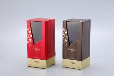 We are a manufacturer of custom box packaging. This image showcases our product line: two distinct perfume boxes set against a neutral gray background. The box on the left features a bold red design, while the box on the right presents an elegant brown hue. Both boxes carry our brand "zimaya" and are labeled as "eau de parfum.