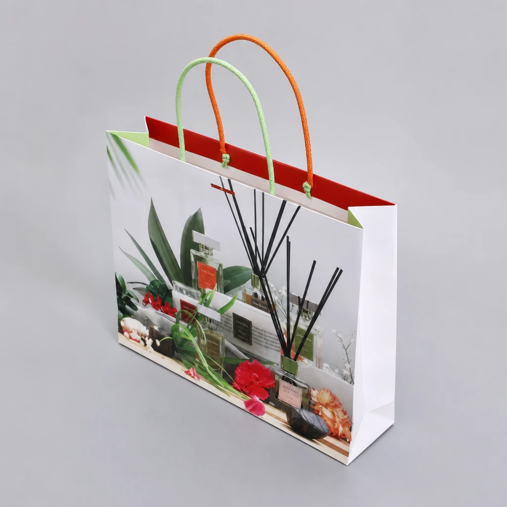 Perfume paper shopping bag showing rope handles and side gusset