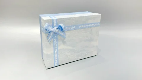 The boxes feature a blue and marbled pattern with a practical lift-off lid and are elegantly finished with blue ribbons.