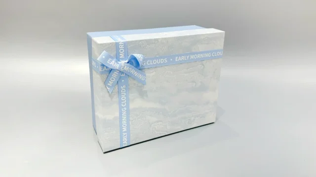 The boxes feature a blue and marbled pattern with a practical lift-off lid and are elegantly finished with blue ribbons.