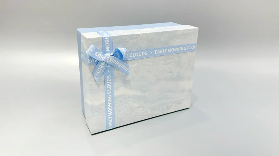 The boxes feature a blue and marbled pattern with a practical lift-off lid and are elegantly finished with blue ribbons.