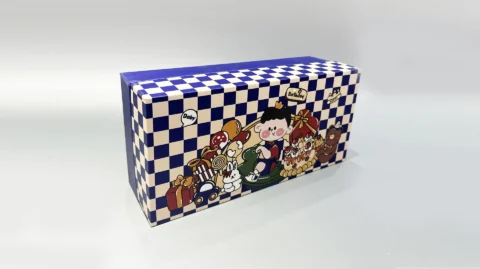 This custom packaging box showcases playful cartoon characters, including a cheerful pig and a chicken, surrounded by a delightful assortment of pastries. The vibrant design is set against an imaginative checkered backdrop, creating an eye-catching presentation for any gift.