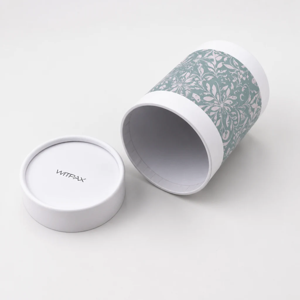 Round tube packaging showing open rim, liner, and floral band