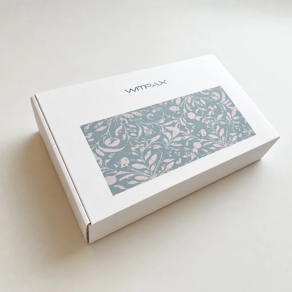 White folding carton with decorative floral panel viewed from above