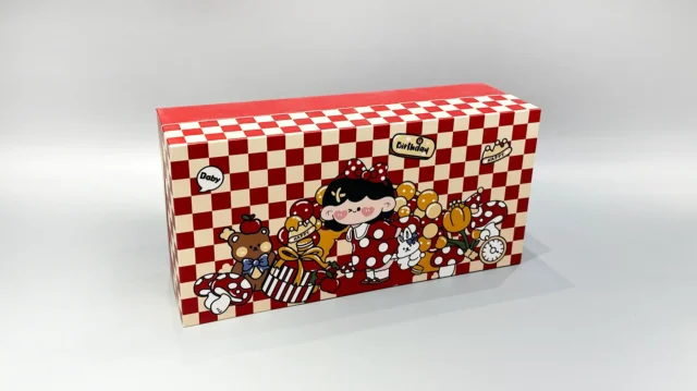 Our product is a custom-designed rectangular gift box in an appealing red color, featuring a checkered lid adorned with playful cartoon characters and food-themed illustrations. This versatile packaging solution is ideal for enhancing any occasion.