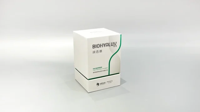 Two custom skincare packaging boxes are stacked on a gray surface, with their lift-off lids slightly ajar. The boxes showcase intricate designs and craftsmanship.