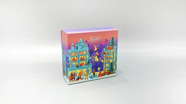 The image showcases a vibrant, customized gift box adorned with lively illustrations of people and animals. It features a unique skincare packaging design, paired with a distinct purple lift-off lid placed nearby.