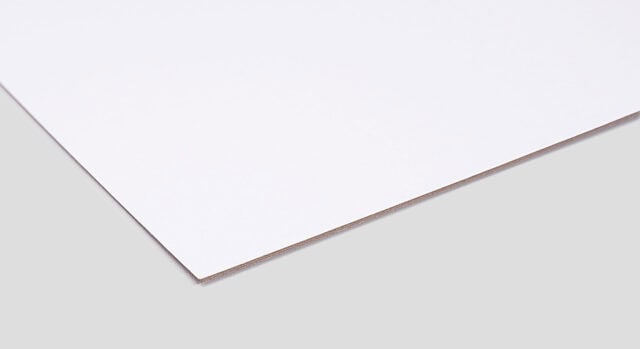 A sheet of white duplex chipboard, showcasing a smooth, flat surface with a slight sheen, placed on a light gray background.