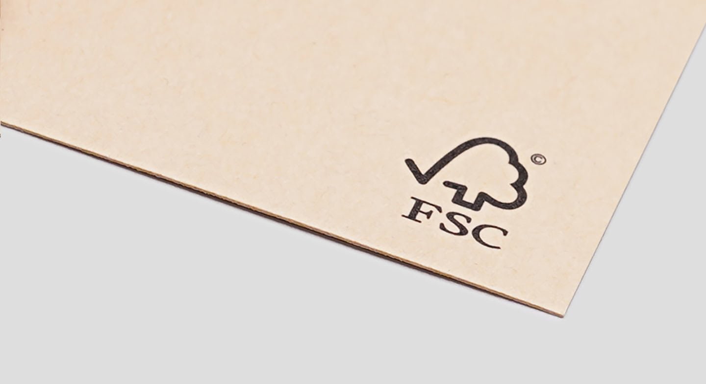 A close-up image of a natural color sheet of paper with the FSC logo, indicating it is made from certified sustainable forest sources.