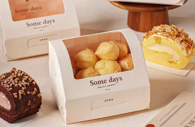Assorted pastries with window patching in packaging on a table.