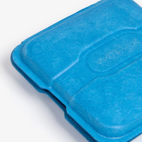 Blue molded pulp box insert showing detailed corner view with embossed branding