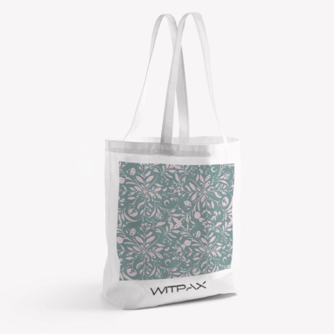 Front view of white canvas tote bag with sage green and pink floral pattern and WITPAX branding