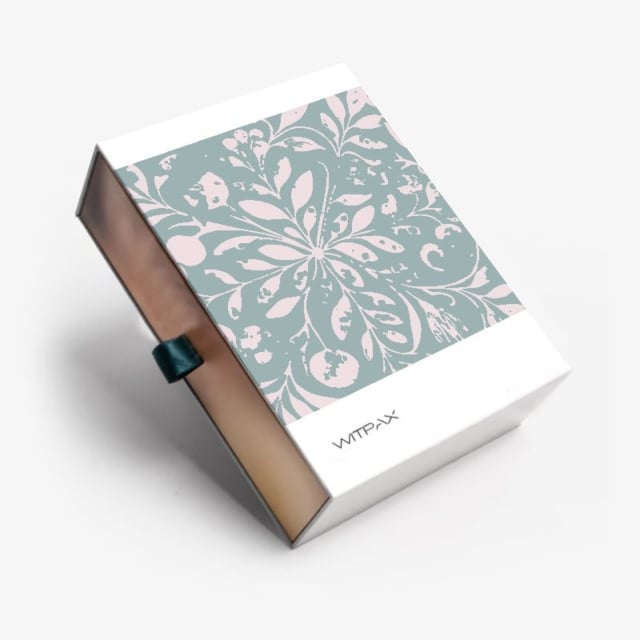 Custom collapsible rigid box with sage green floral pattern lid and bronze base, shown partially open with ribbon pull tab