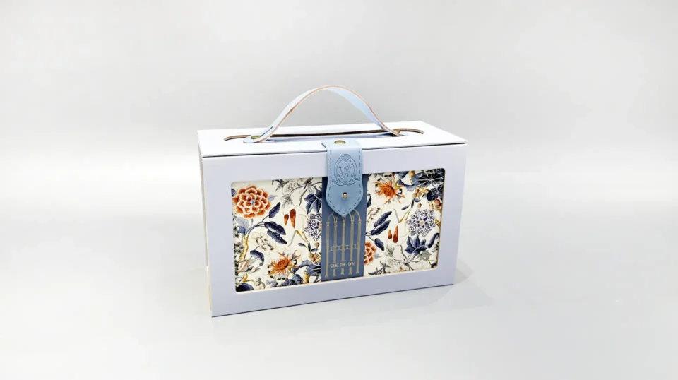 Custom-designed portable box packaging with a lid and handle, showcasing an elegant floral and bird pattern in blue, orange, and white tones. Ideal for gifting or personal use.
