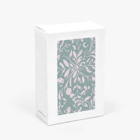 Custom white folding carton with clear window showing floral pattern insert in closed position