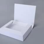Foldable magnetic white box with a raised lid on a gray background.