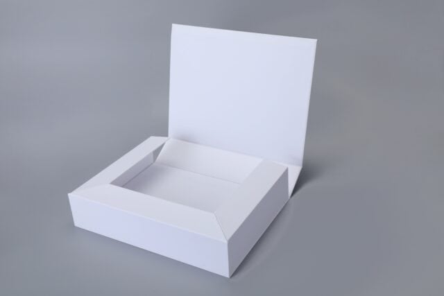 Foldable magnetic white box with a raised lid on a gray background.