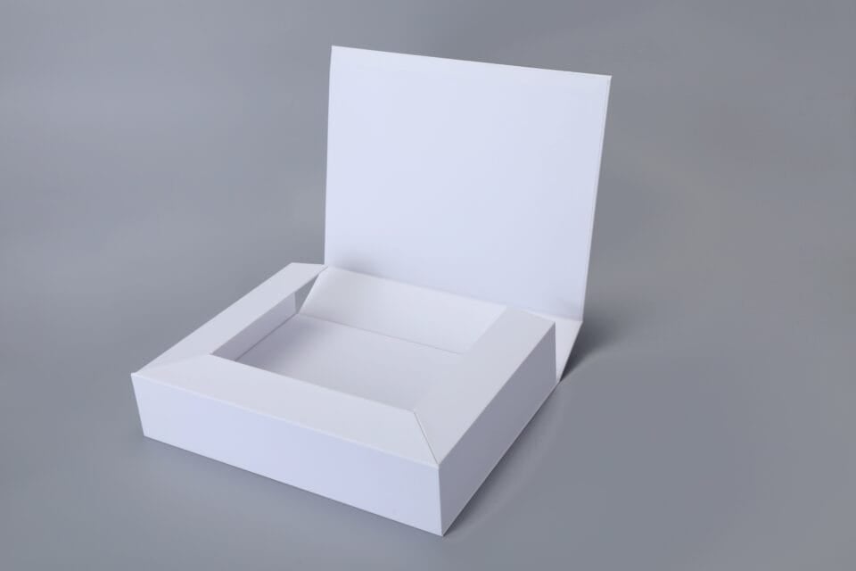 Foldable magnetic white box with a raised lid on a gray background.