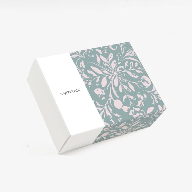 Closed custom folding carton showing floral pattern on top and sides with WITPAX branding on white panel