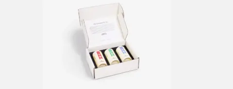 Garrett x WITPAX open box with colored deodorants and a leaflet inside.