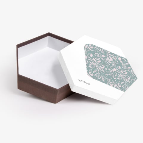 Custom hexagonal rigid box shown open with decorative patterned lid interior and brown textured base