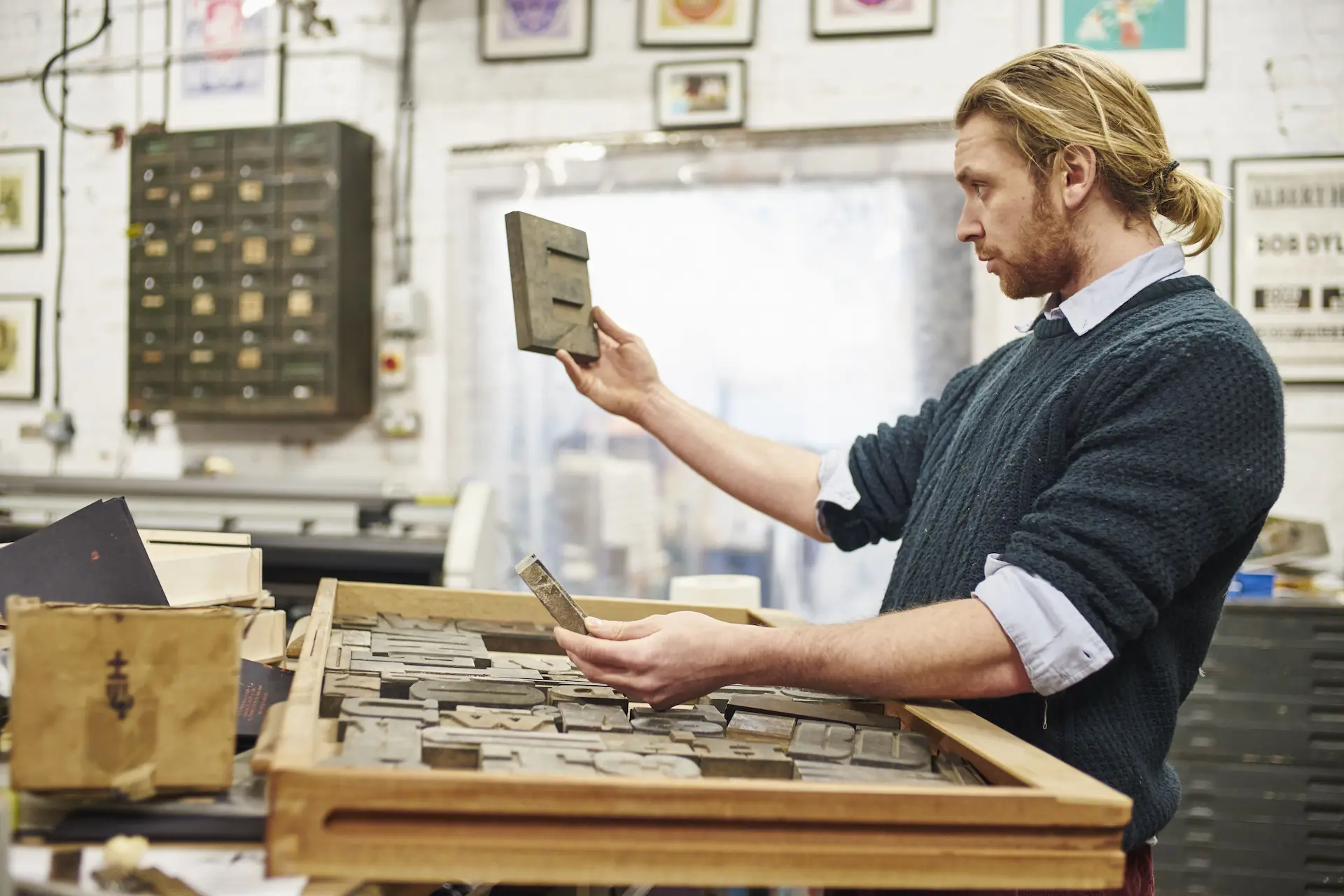 man checking letterpress blocks