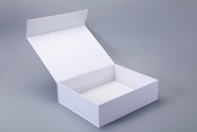 Open white box with a hinged lid and magnetic closure on a gray background.
