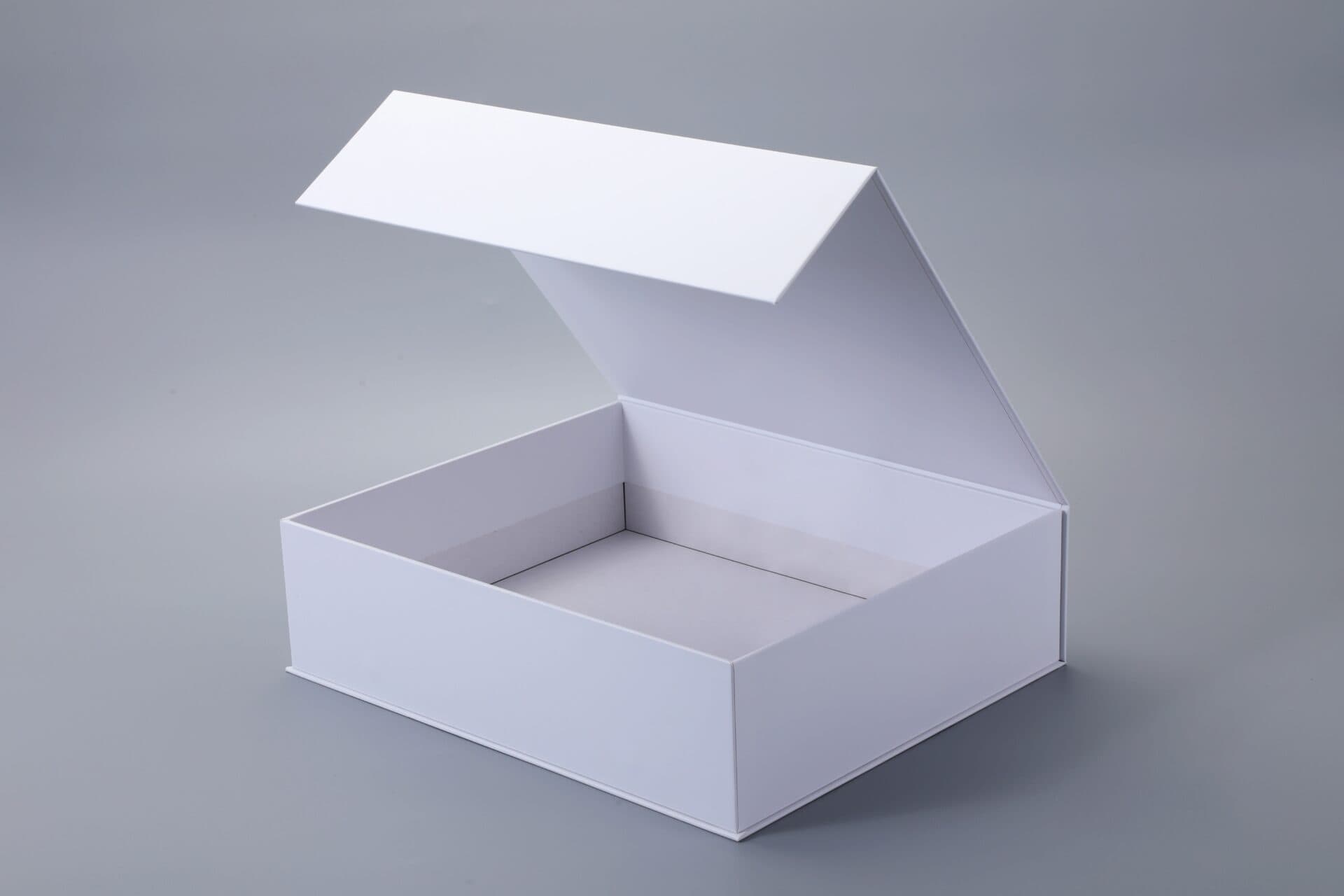 Open white box with a magnetic closure on a gray background.