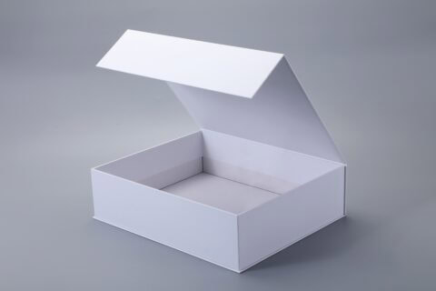 Open white box with a magnetic closure on a gray background.