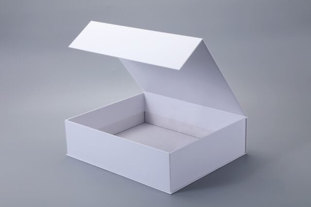 Open white box with a magnetic closure on a gray background.
