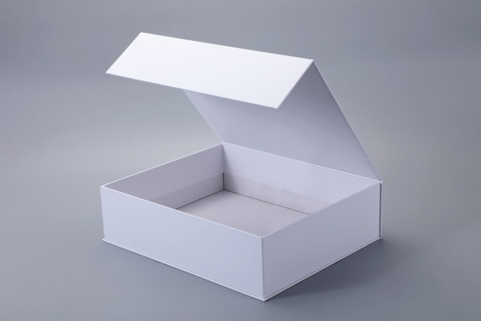 Open white box with a magnetic closure on a gray background.