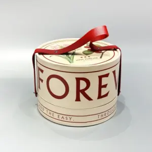 Round shaped lift-off lid box with strap