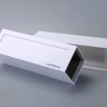 Sliding drawer box with label, slightly open on a gray surface.