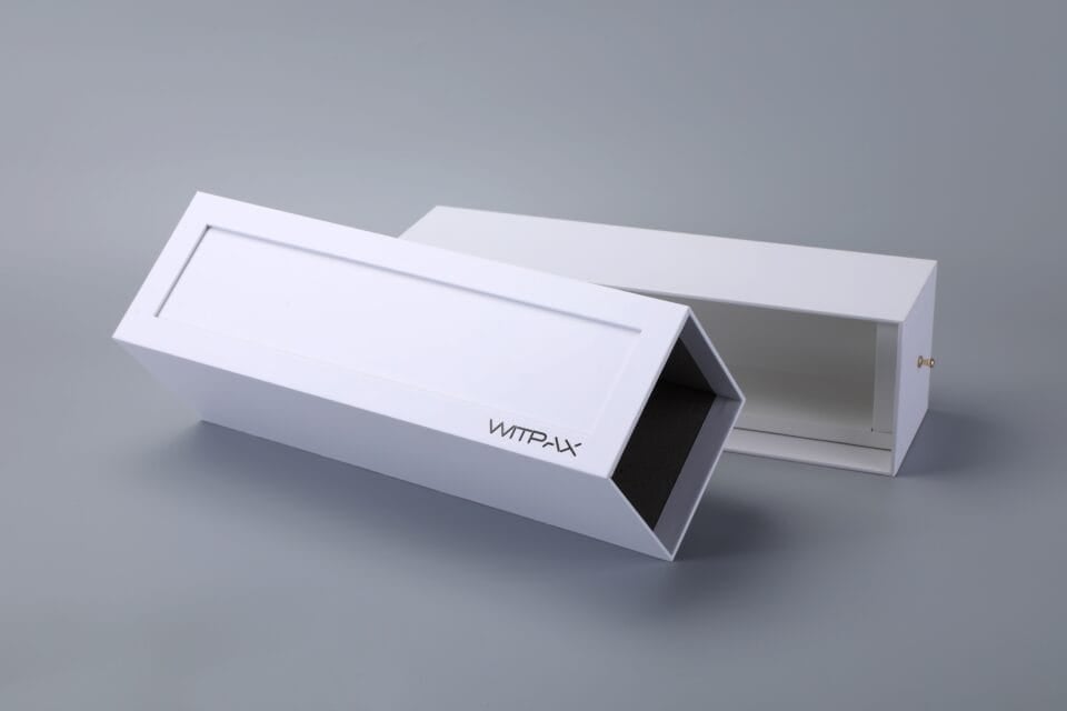 Sliding drawer box with label, slightly open on a gray surface.