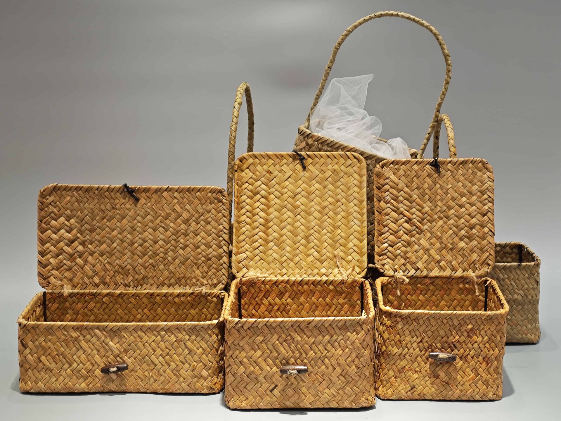 The image features several custom packaging boxes arranged open, showcasing their textured designs. A plastic liner is visible inside one portable box.