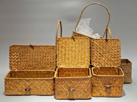 The image features several custom packaging boxes arranged open, showcasing their textured designs. A plastic liner is visible inside one portable box.