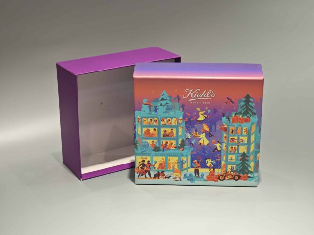 The image showcases a vibrant, customized gift box adorned with lively illustrations of people and animals. It features a unique skincare packaging design, paired with a distinct purple lift-off lid placed nearby.