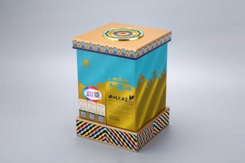 This image depicts a vibrant packaging box featuring intricate patterns and a car design, complemented by a circular emblem on the lid.
