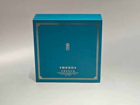 This image showcases our custom packaging solution: a blue gift box designed for cultural heritage items. It features elegant gold detailing and combines traditional and contemporary aesthetics, incorporating both English and Chinese elements.