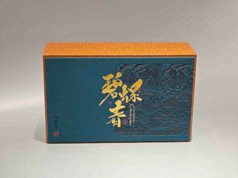 This product is a custom decorative packaging box featuring an elegant design in blue and orange hues, complemented by gold accents on the front.