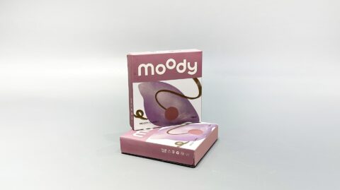 Two custom-designed pink folding cartons with abstract patterns are showcased against a plain background, harmonizing seamlessly with the brand's unique contact lens collection.