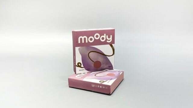 Two custom-designed pink folding cartons with abstract patterns are showcased against a plain background, harmonizing seamlessly with the brand's unique contact lens collection.