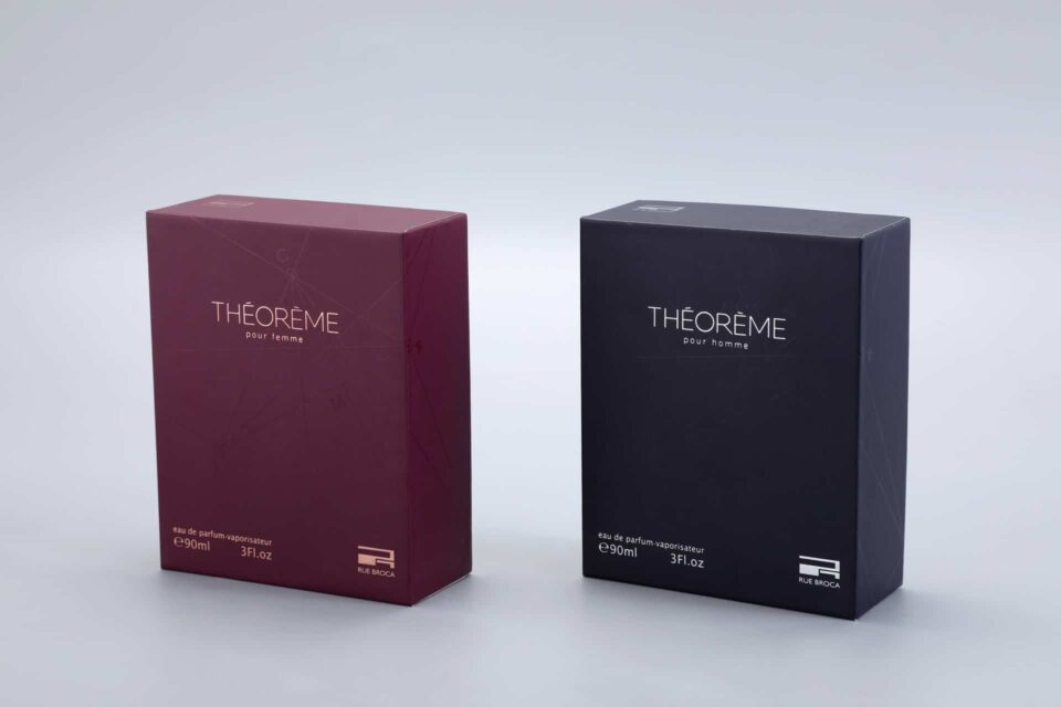 Two custom perfume boxes are positioned side by side. One is maroon and the other is black, each designed to hold 90ml or 3 fl oz of product.