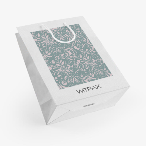 Angled view of white paper shopping bag with sage green floral pattern window and rope handles