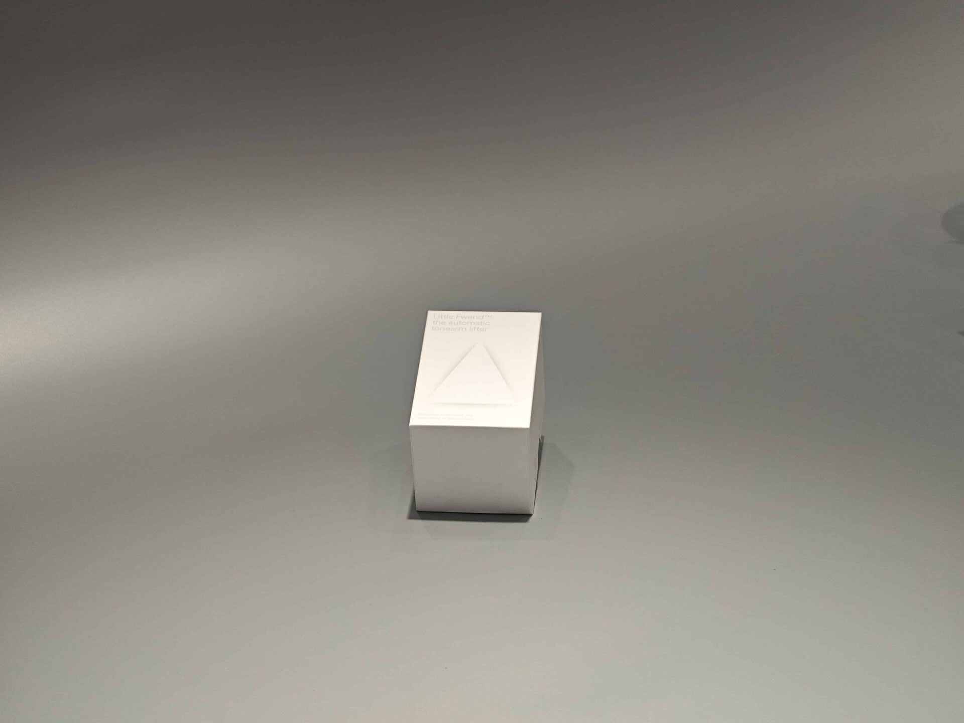 White folding cartons are displayed, one in an upright position and the other partially opened