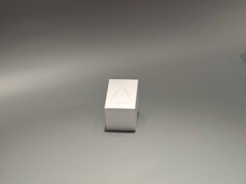 White folding cartons are displayed, one in an upright position and the other partially opened