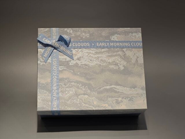 The boxes feature a blue and marbled pattern with a practical lift-off lid and are elegantly finished with blue ribbons.